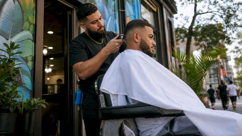 Barber giving skin fade haircut in shop