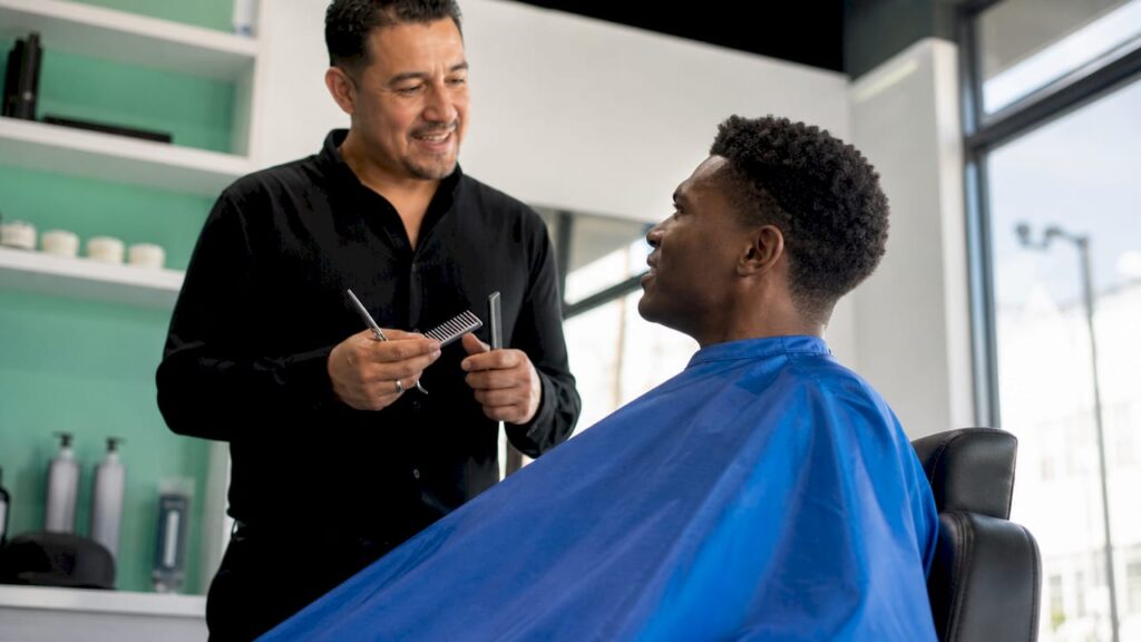 Man consulting barber about hairstyle