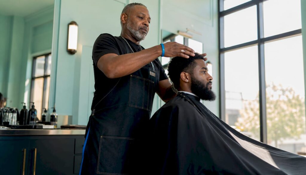 Barber applying quality products in barbershop