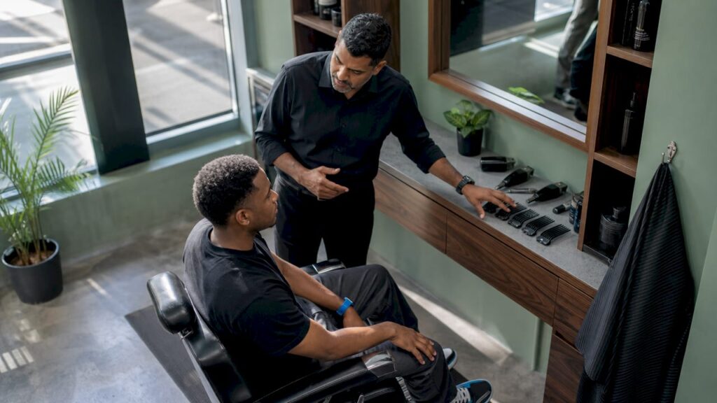 Barber consulting client about haircut length
