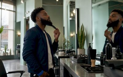 Man checking phone at barber shop waiting area