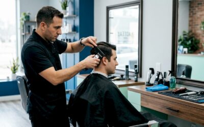 Barber fixing a man's uneven haircut