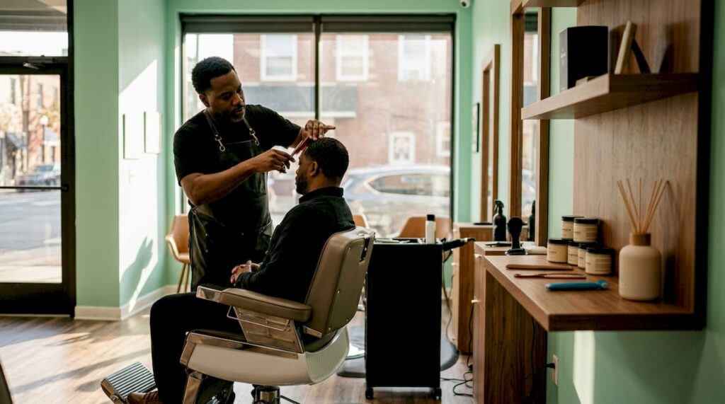 Barber trimming hair in classic styled barbershop