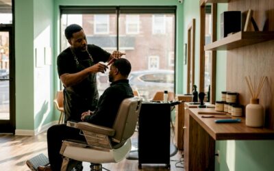 Barber trimming hair in classic styled barbershop