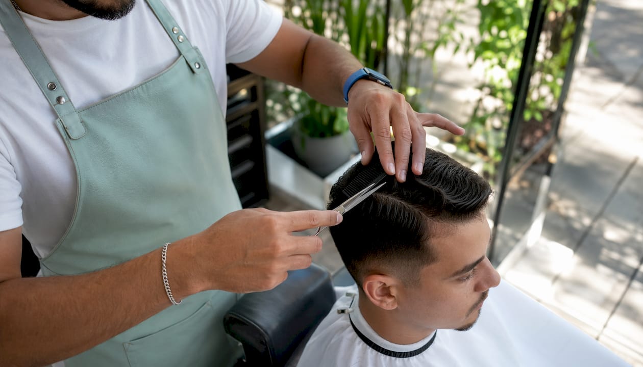 Barber performing scissor-over-comb technique
