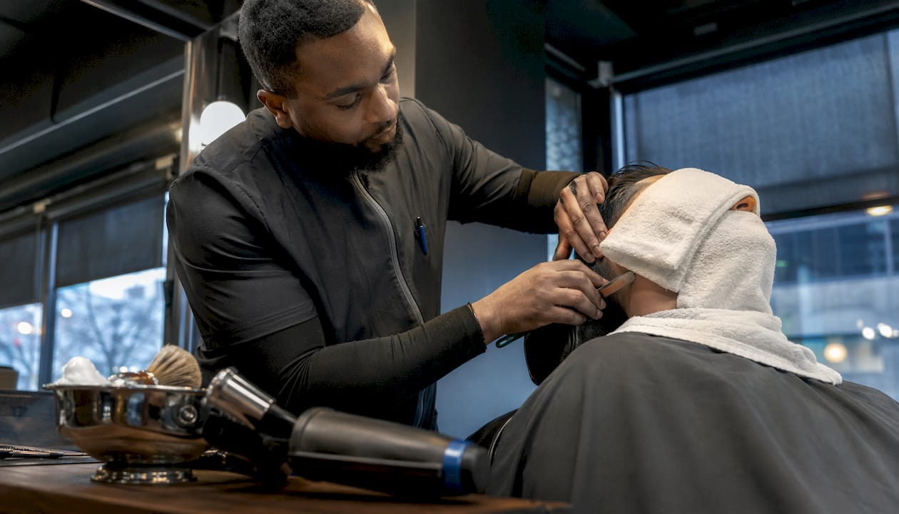 Barber performing straight-razor shave