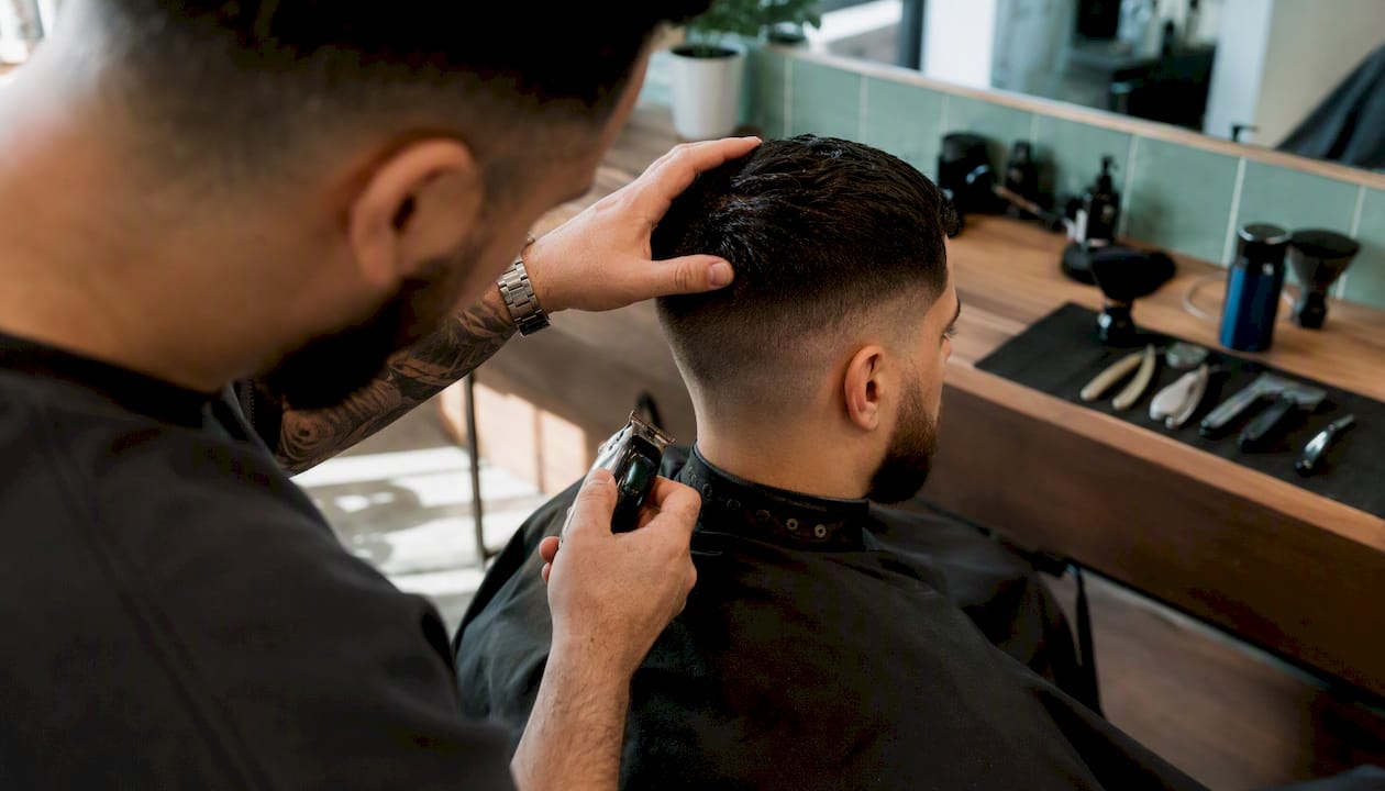 Barber inspecting contrast fade transition zone
