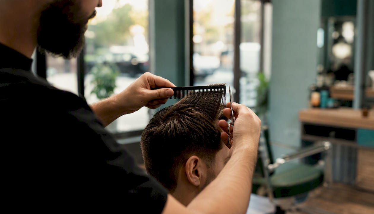 Barber holding hair section with tension