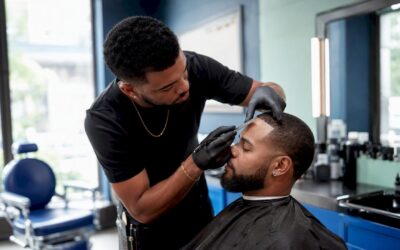 Barber shaping hairline with razor