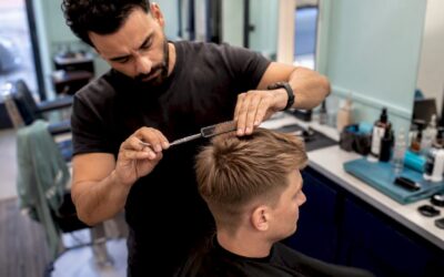 Barber precisely cutting Scandinavian hairstyle